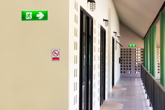 Photo green emergency exit sign to install over the door building construction showing the way to escape