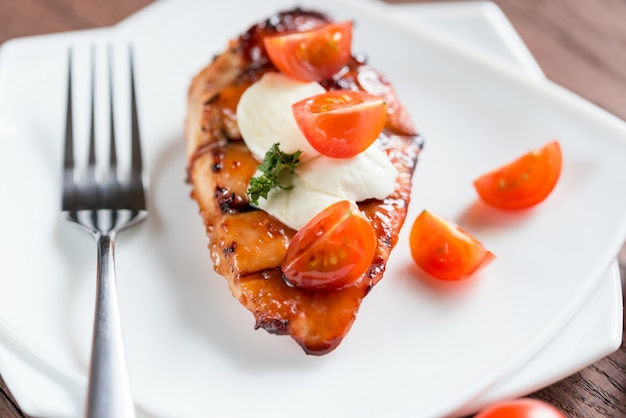 Grilled chicken steak with mozzarella and cherry tomatoes