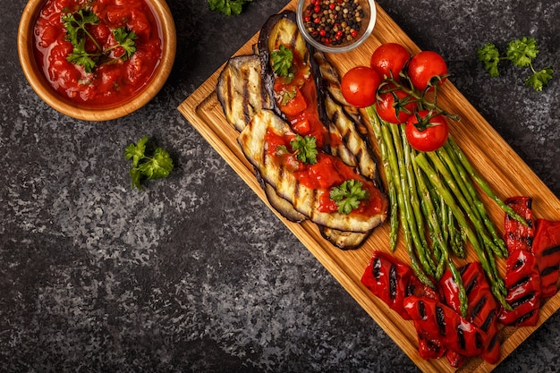 Grilled vegetables with tomato sauce and fresh herbs.