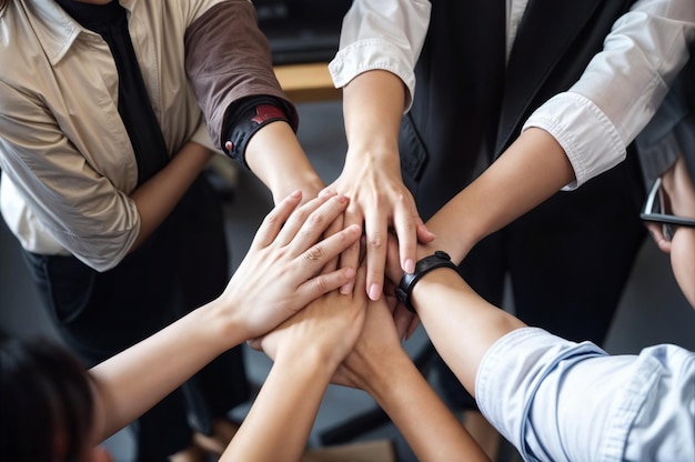 Photo group of people joining hands in a team building gesture