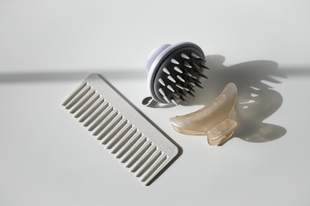 Photo hair comb scalp massager and hair clip on white background