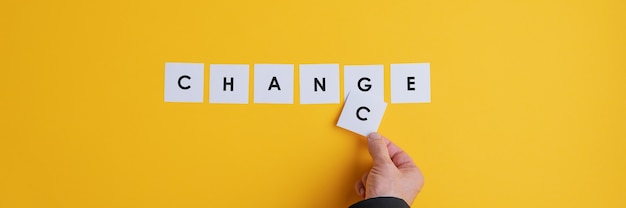 Photo hand of a businessman changing the word change into chance.