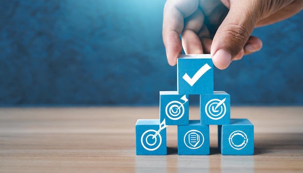 Photo hand holding white correct sign mark on blue wooden block cube and the top of document icon for iso