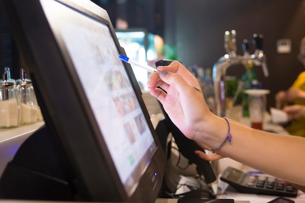 Photo the hand of a person working with a touch screen monitor