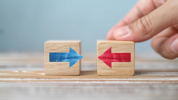 Photo hand putting a wooden cube with red arrow showing the opposite to blue arrows direction