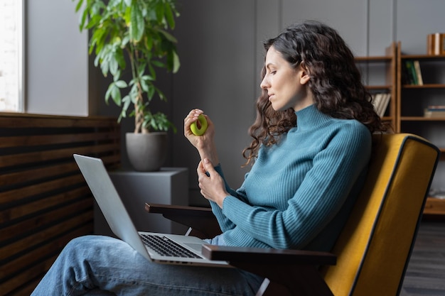 Hand and wrist exercises for office workers female employee using carpal expander to relieve stress