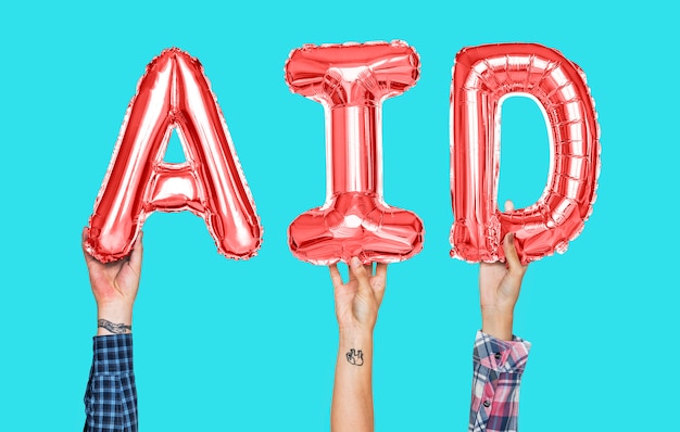 Hands holding aid word in balloon letters