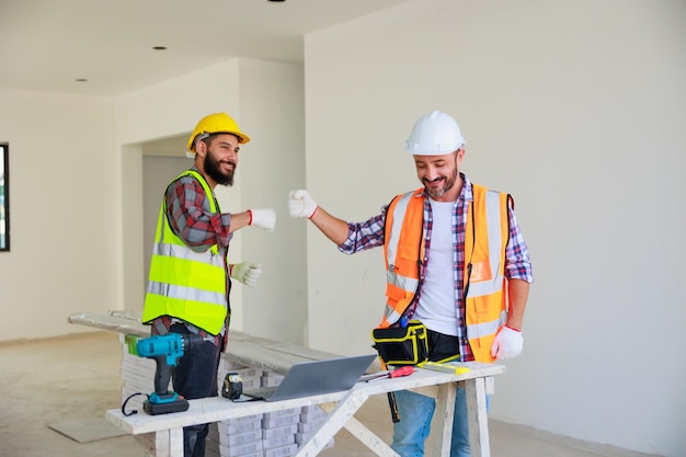 Handshake Electrician and construction engineer man team in safety uniform working and  planing in construction site