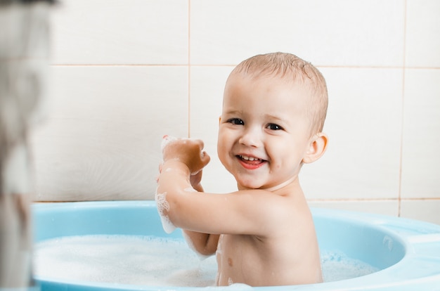 Handsome boy preschooler bathing in the bathroom clean and hygienic