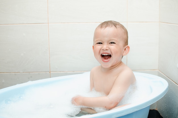 Handsome boy preschooler bathing in the bathroom clean and hygienic