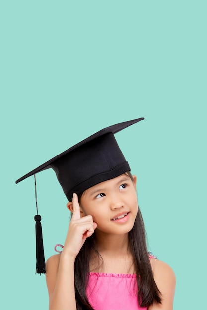 Happy Asian school girl with copy space Student child graduate in graduation cap