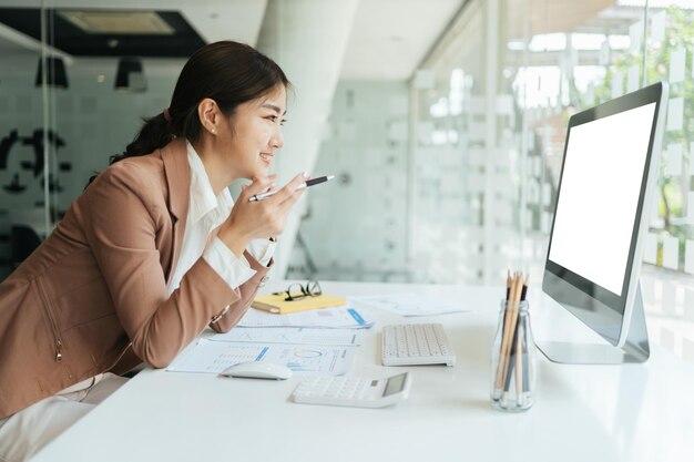 Photo happy attractive asian business woman working with a laptop and financial document at office successful action business concept