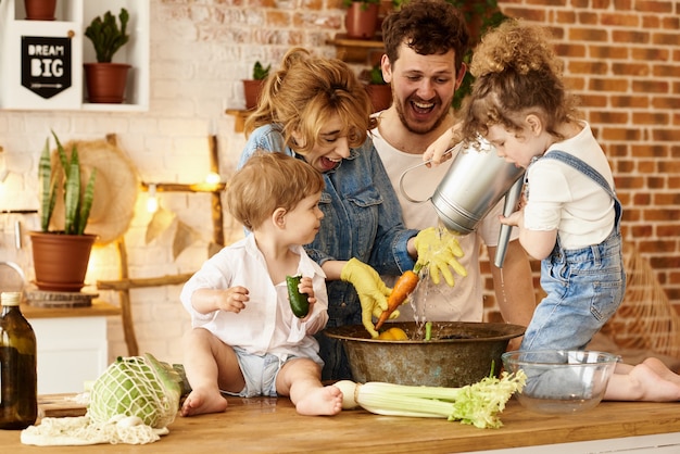 Happy family with their children cooking in the kitchen