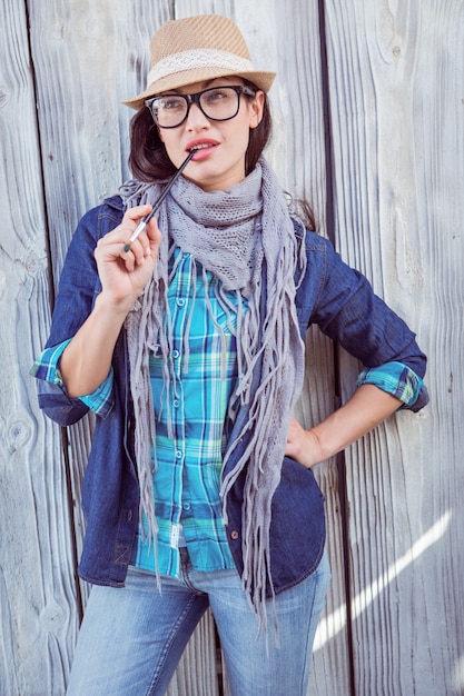 Happy hipster holding a paintbrush