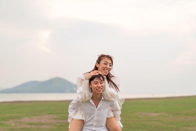 Happy young Asian couple in bride and groom clothing