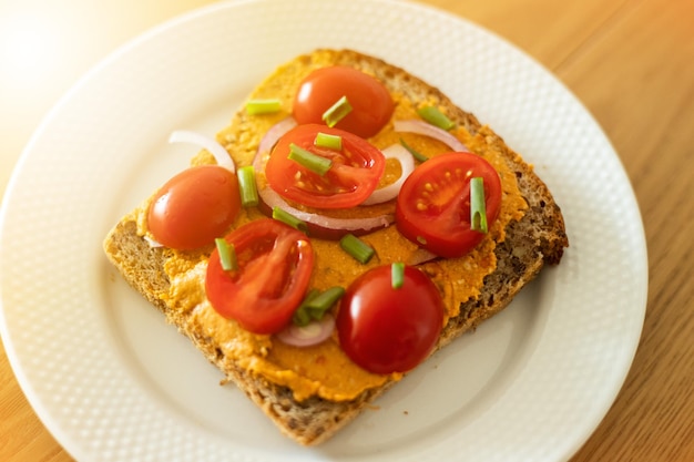 Healthy sandwich with vegan cream and tomatoes