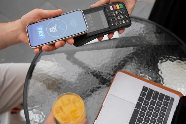 Photo high angle customer paying with nfc device