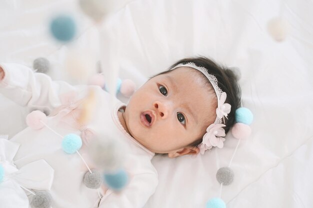 Photo high angle view of cute baby girl lying on bed