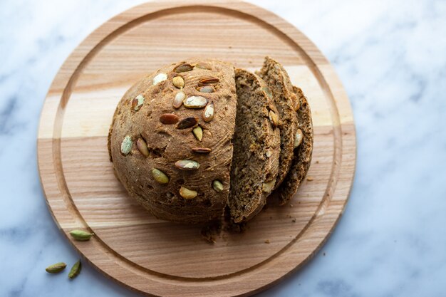 Homemade bread with pumpkin seeds on the board.