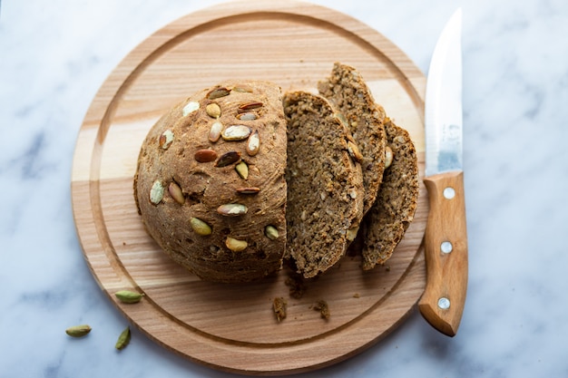 Homemade bread with pumpkin seeds on the board.