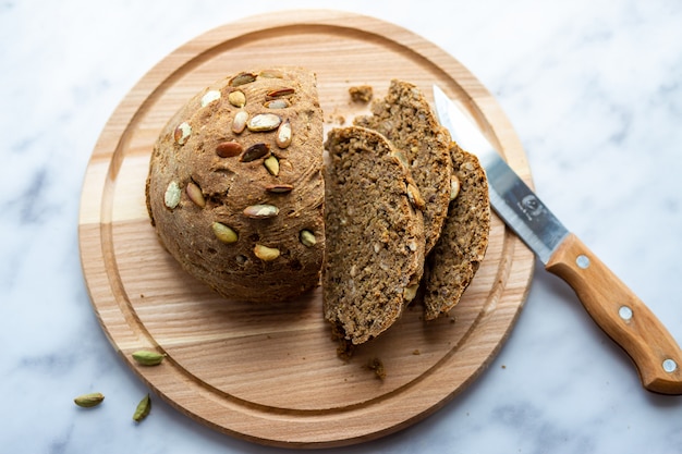 Homemade bread with pumpkin seeds on the board.