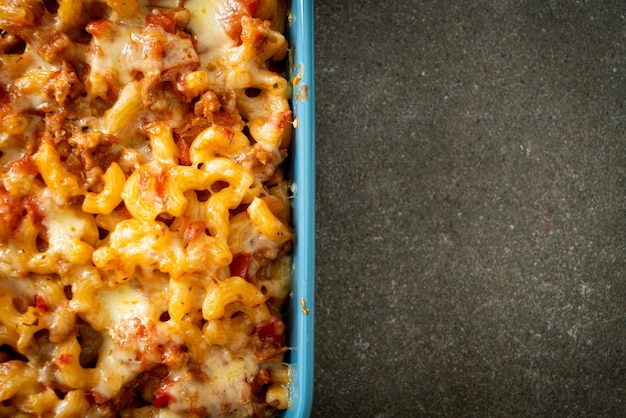 Homemade macaroni bolognese with cheese