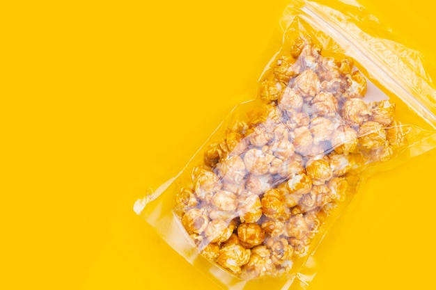 Honey caramel popcorn on yellow background