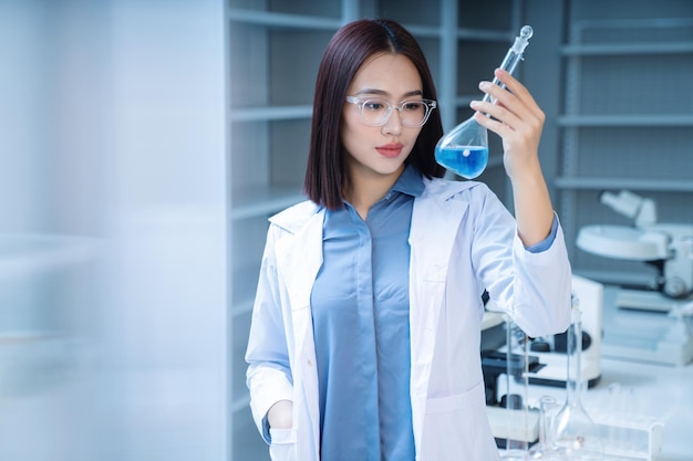 Photo image of young asian woman working in the lab