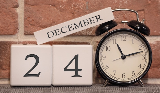 Photo important date december 24 winter season calendar made of wood on a background of a brick wall