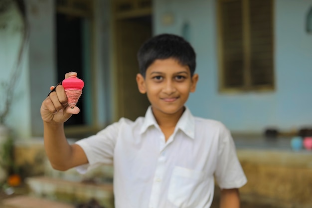 Indian child playing with bhovra Lattu Bhovra