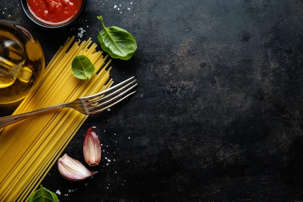 Italian food background with spaghetti spices and sauce View above