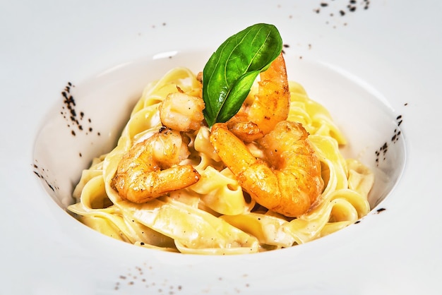 Italian pasta fettuccine in a creamy sauce with shrimps