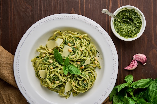 Italian spaghetti pesto with pine nuts garlic basil leaves parmesan cheese and olive oil