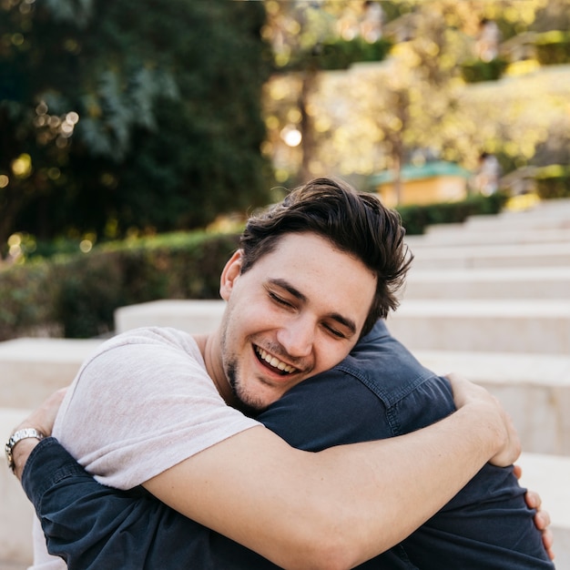 Joyful father and son hugging