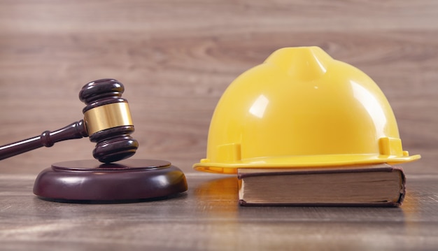 Photo judge gavel and safety helmet. construction law