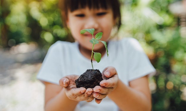 kid planting a tree for help to prevent global warming or climate change