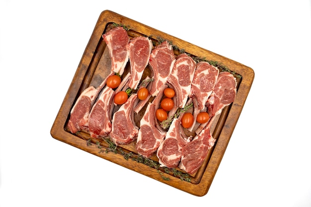 Lamb chops isolated on a white background Raw lamb chops on wood serving board Top view