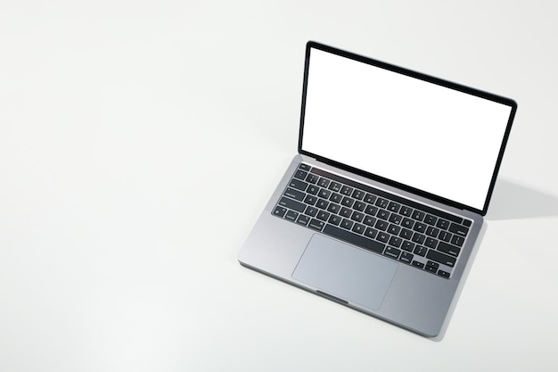 Laptop with blank screen on light background