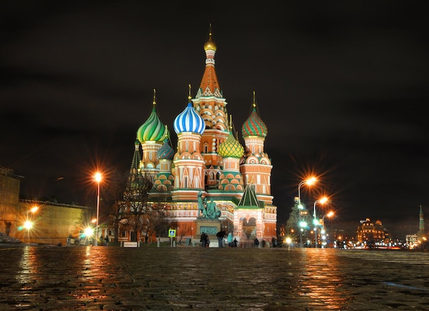 A large church with a green dome and a white sign that says st. basil's.