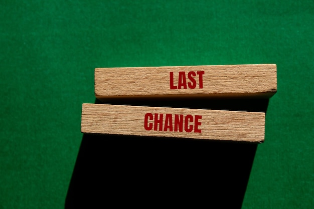 Photo last chance message written on wooden blocks on green background conceptual last chance symbol copy space