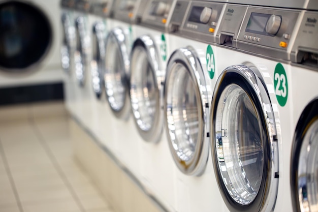 Laundry. Lots of washing machines in the laundry room. Big laundry. Washing machines in a row. Lots