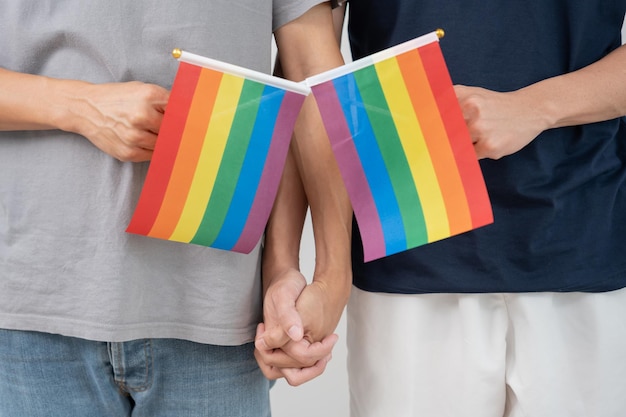 Photo lgbt group male bisexualities couple holding hands encourage and show lgbt flag happily lover in love bisexualities homosexuality liberty expression happy life life style freedom respec