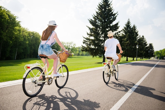 Lovely couple posing together outdoors with bicycles