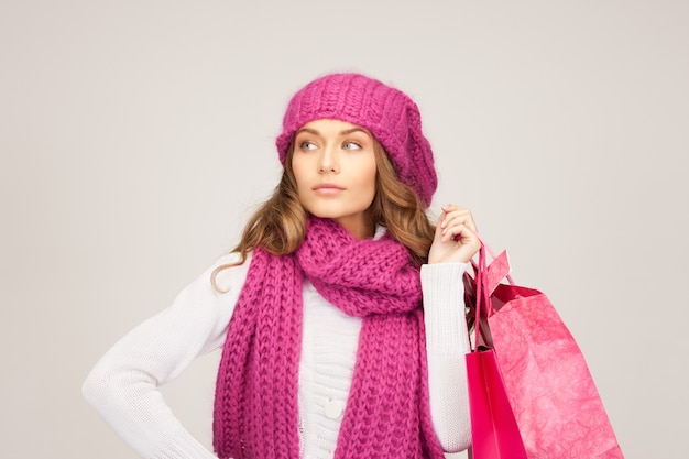 lovely woman with shopping bags over grey