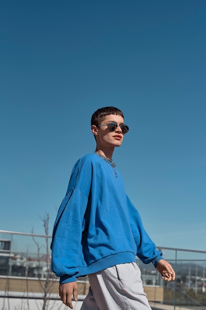 Low angle man walking with sunglasses