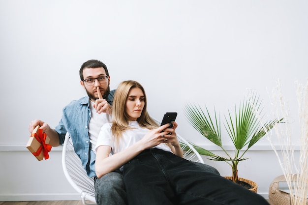 Man surprised her girlfriend with gift, happy couple celebrating valentines day or anniversary