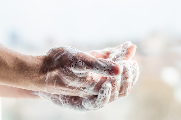 A man washes his hands with soap. Men's hands in a foam with bubbles. Treatment. Hand disinfection. Coronavirus Hygiene Rules