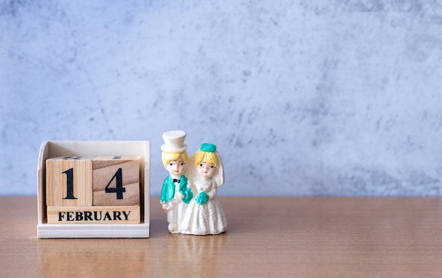 Miniature Wedding couple with wooden calendar 14 february. Valentine s day