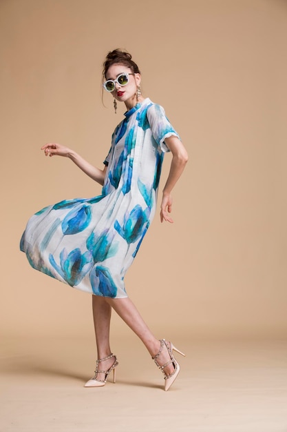 a model wears a dress with a floral print