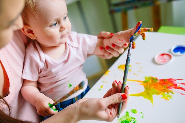 Mom and daughter paint on canvas at the drawing school